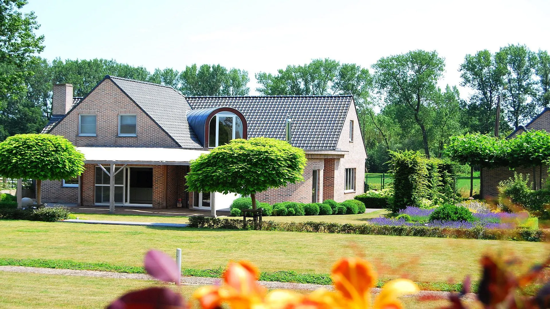 Bakstenen villa met tuin en volwassen bomen